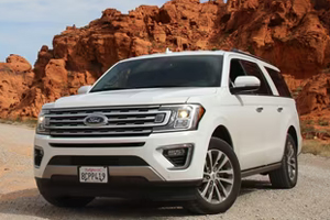 A customer inspecting a well-maintained old car at Jabalpur Car Bazar, the top lot for used cars in Jabalpur.